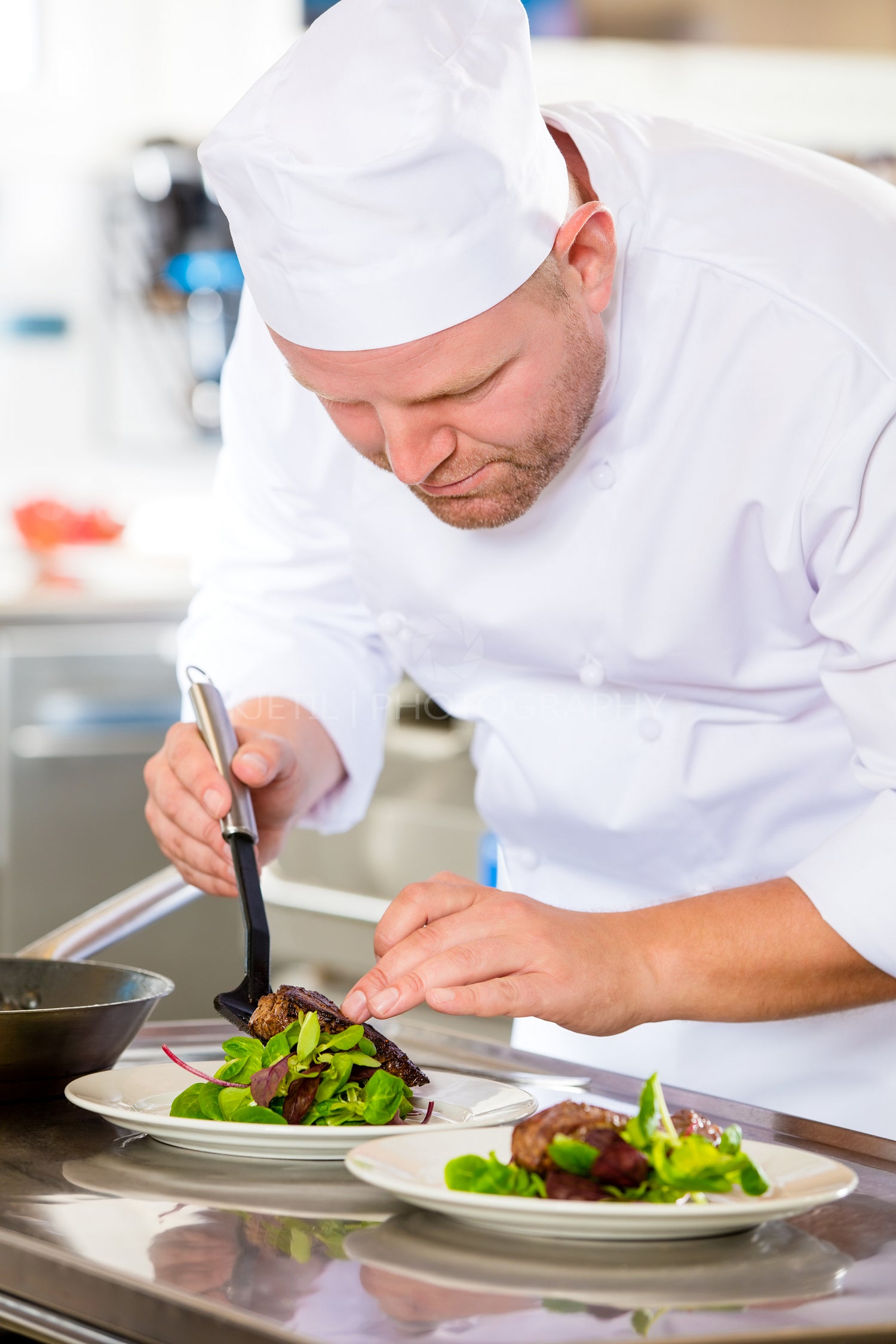 Chef prepares steak dish at gourmet restaurant