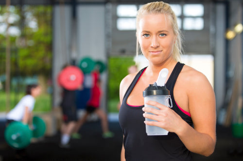 Attractive blonde woman rests at fitness gym