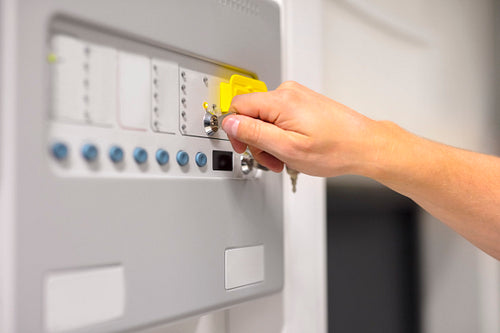 IT Engineer Using Key To Open Fire Panel In Datacenter