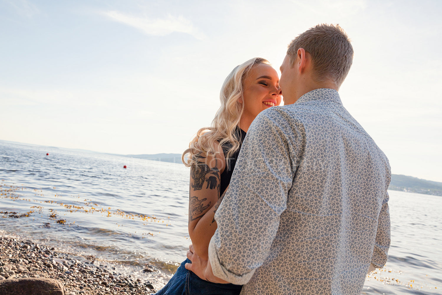 Beautiful Young Couple Kissing At Beach On Sunny Day