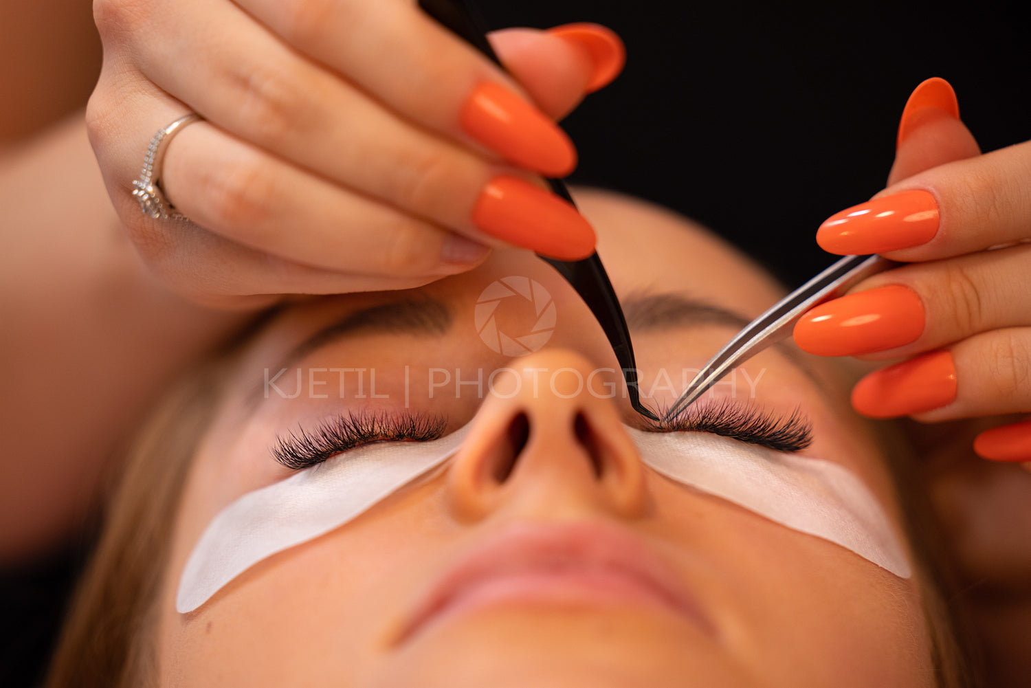 Hands Of Beauty Specialist Using Tweezers On Female Client