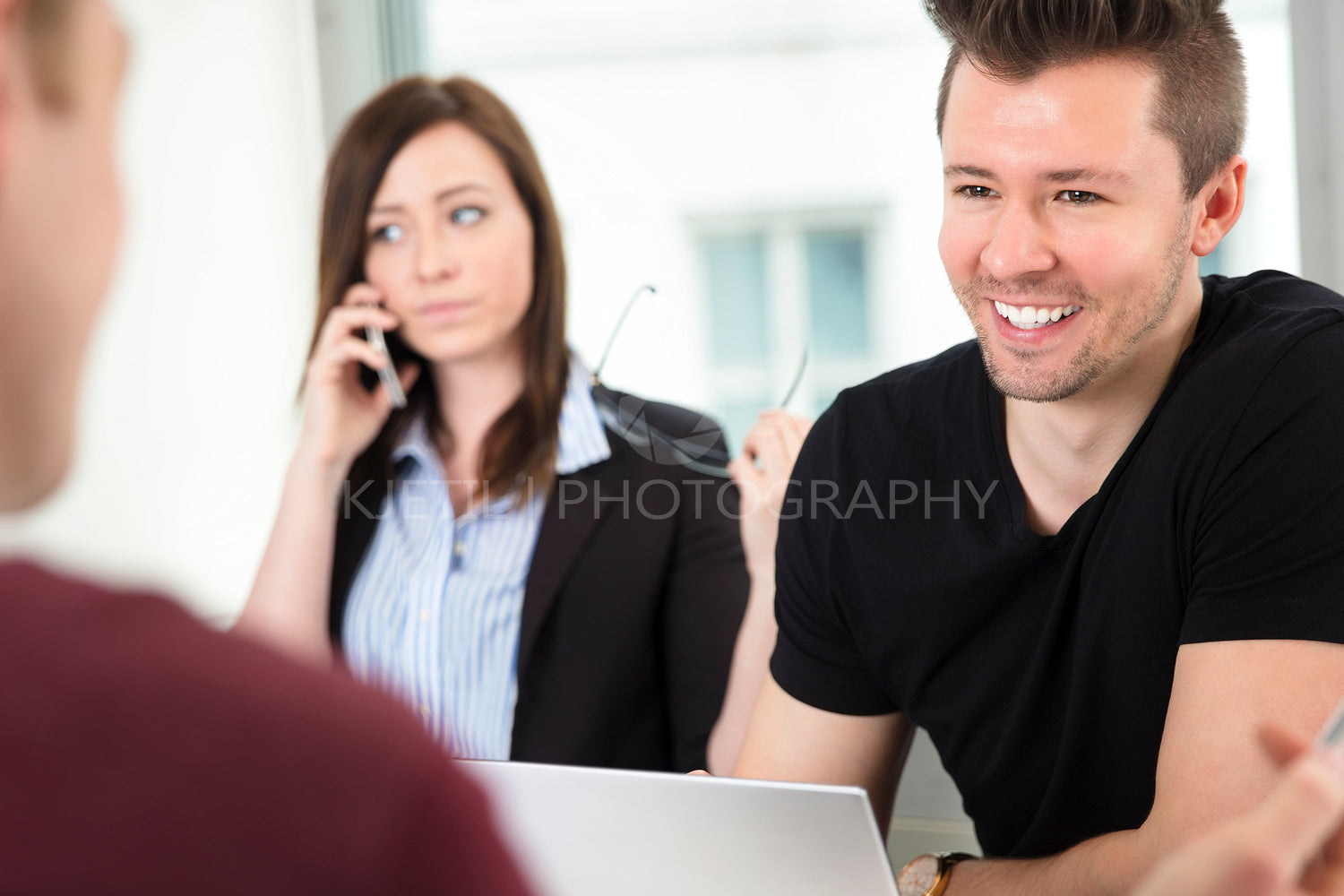 Young Businessman Smiling While Looking At Colleague