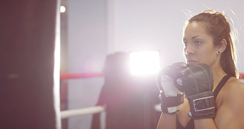 Fast and hard hitting female boxer training in boxing club