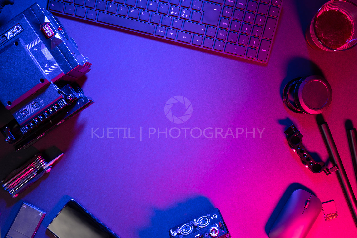 Overhead view of computer parts coffee and video camera on illuminated table