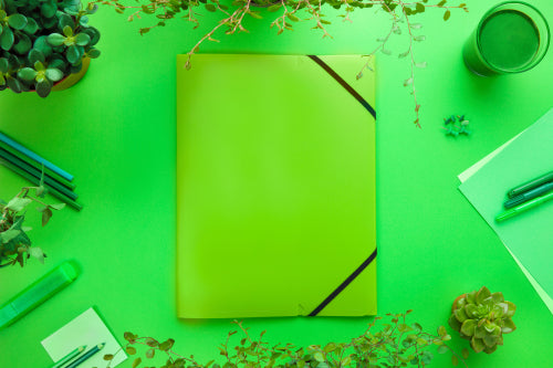 Green Concept of a Folder And Office Supplies On Desk
