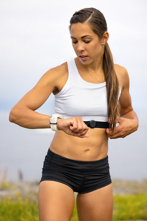 Portrait of woman using fitness smart watch device under workout