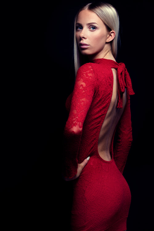 Dark portrait of a blonde woman in red dress