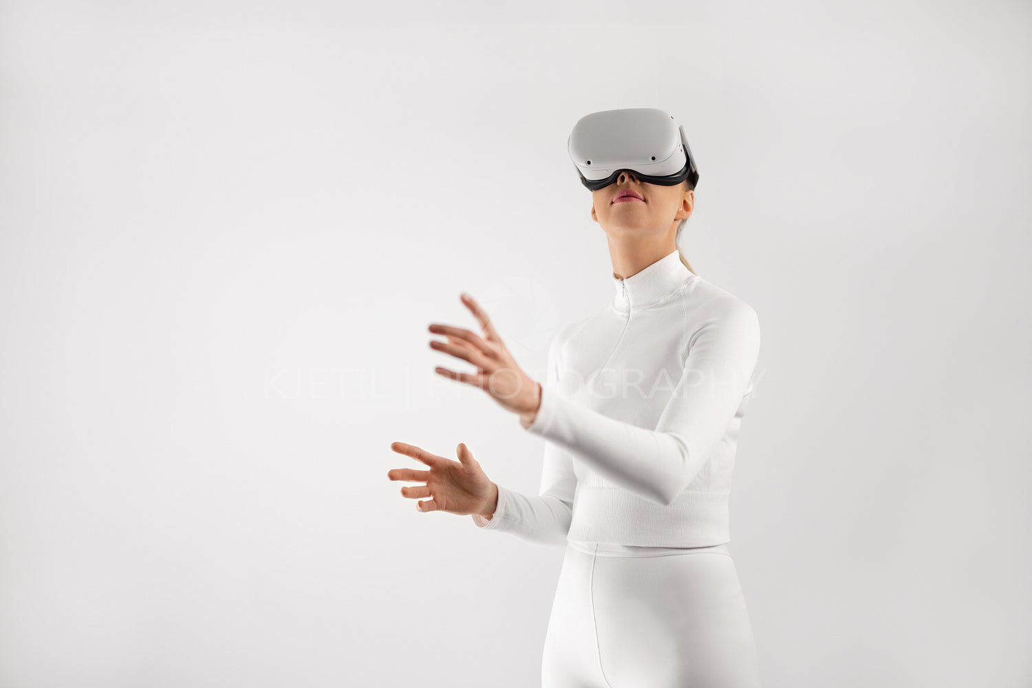 Woman in white wearing VR headset playing around in the virtual reality metaverse