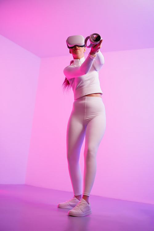 Woman wearing VR glasses practicing golf