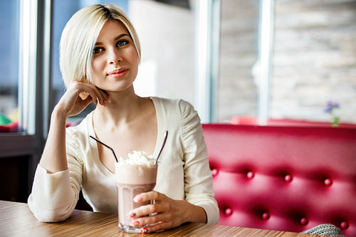 Beautiful Woman Having Hot Chocolate With Cream In Cafe