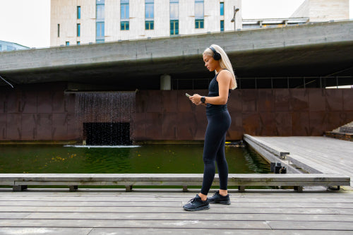 Woman runner start music on smartphone before running