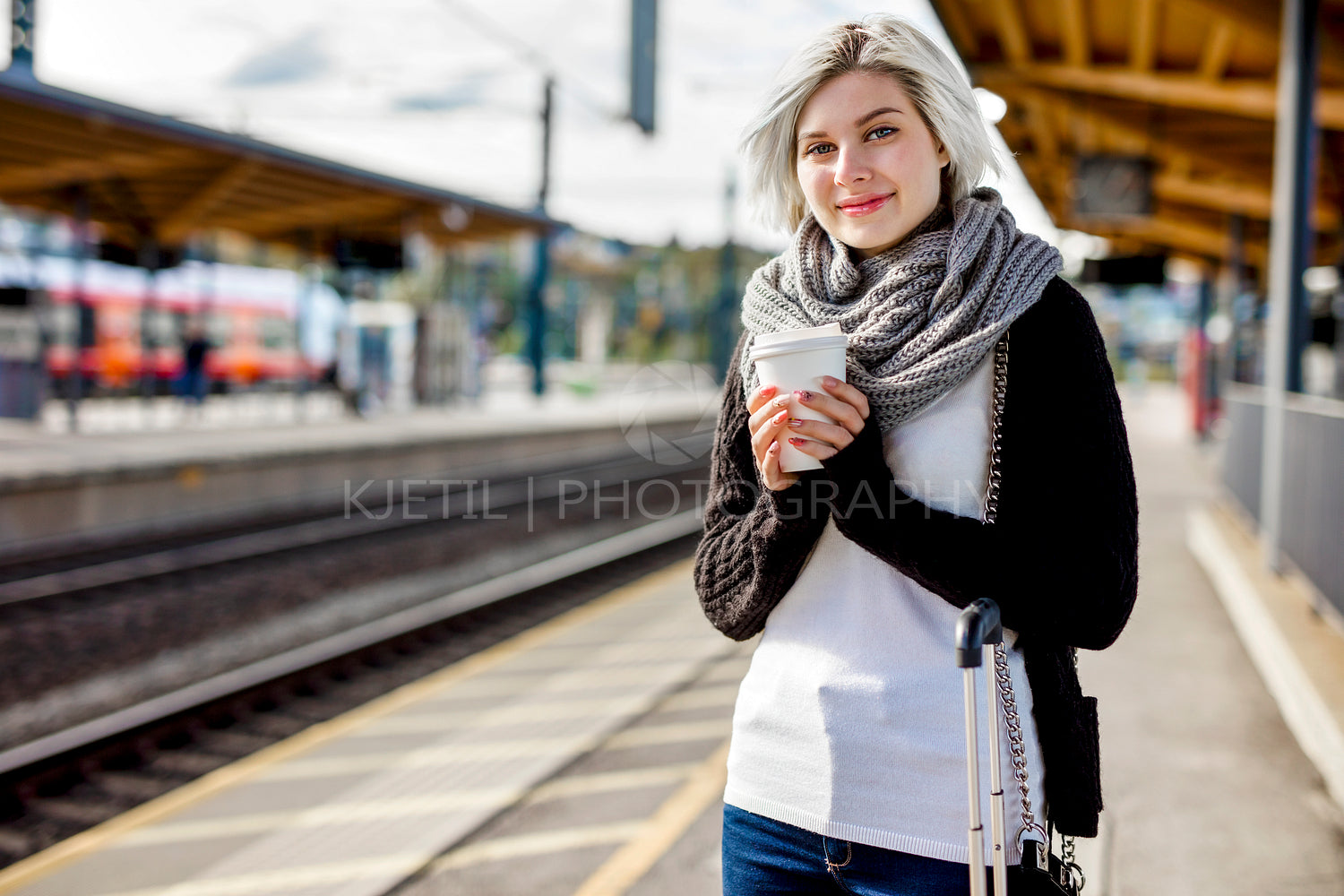 Woman Holding Disposable Coffee Cup At Train Station