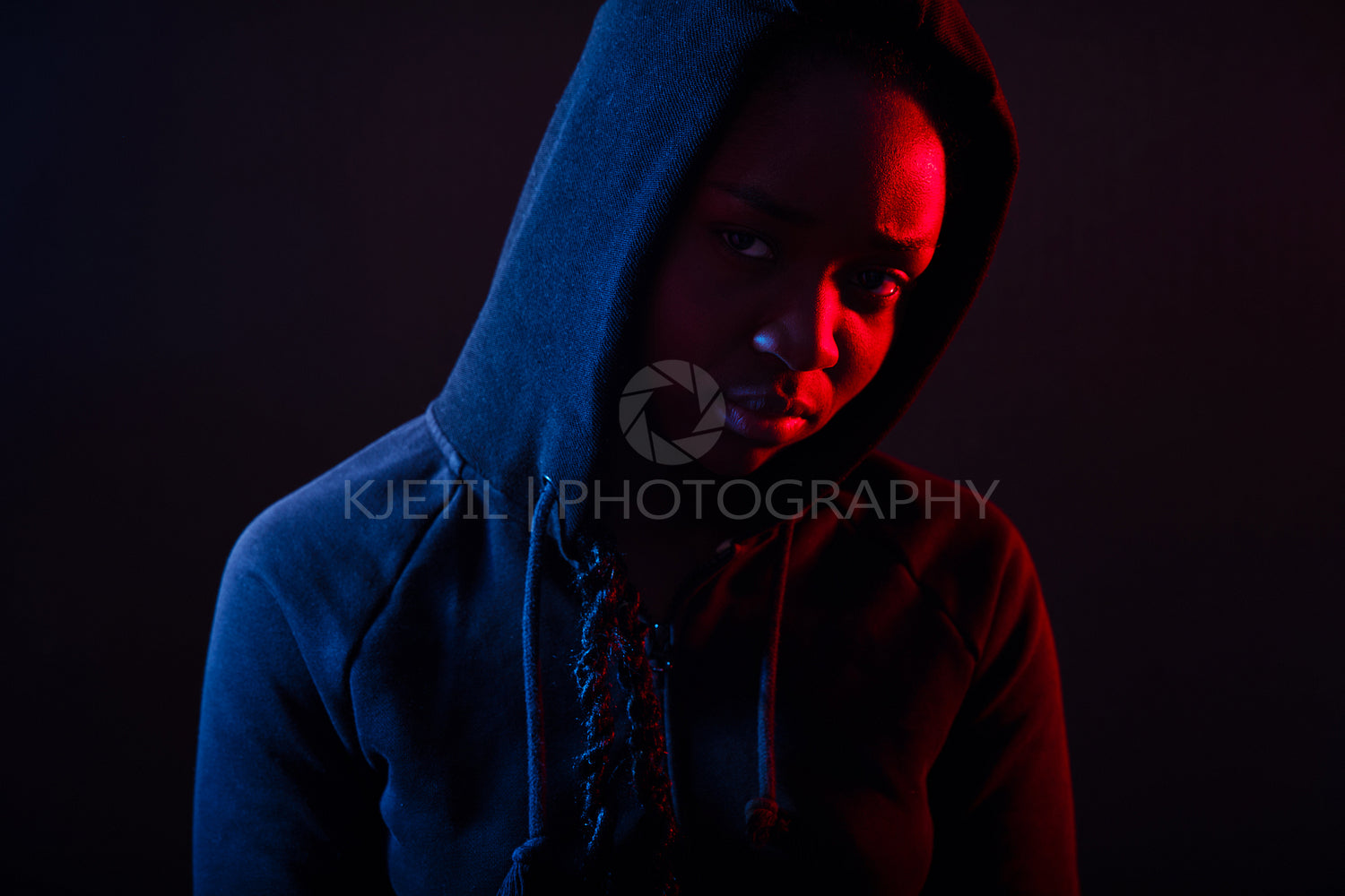 Colorful portrait of thoughtful cool woman with dark skin wearing hoodie