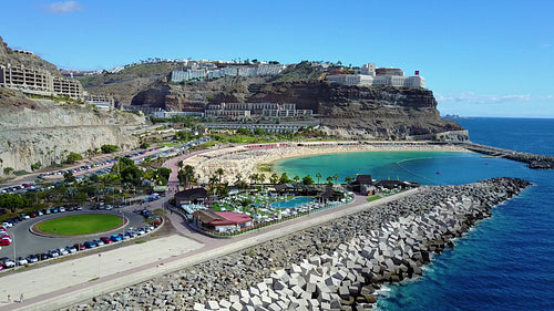 Camera fly over the crowded Amadores beach at Gran Canaria