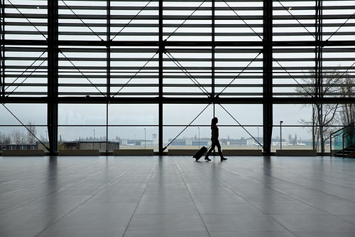 Woman walking in airport terminal