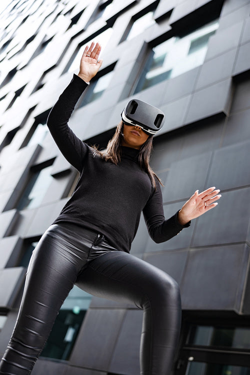 Focused Woman Gesturing With Virtual Reality Glasses In Futuristic City