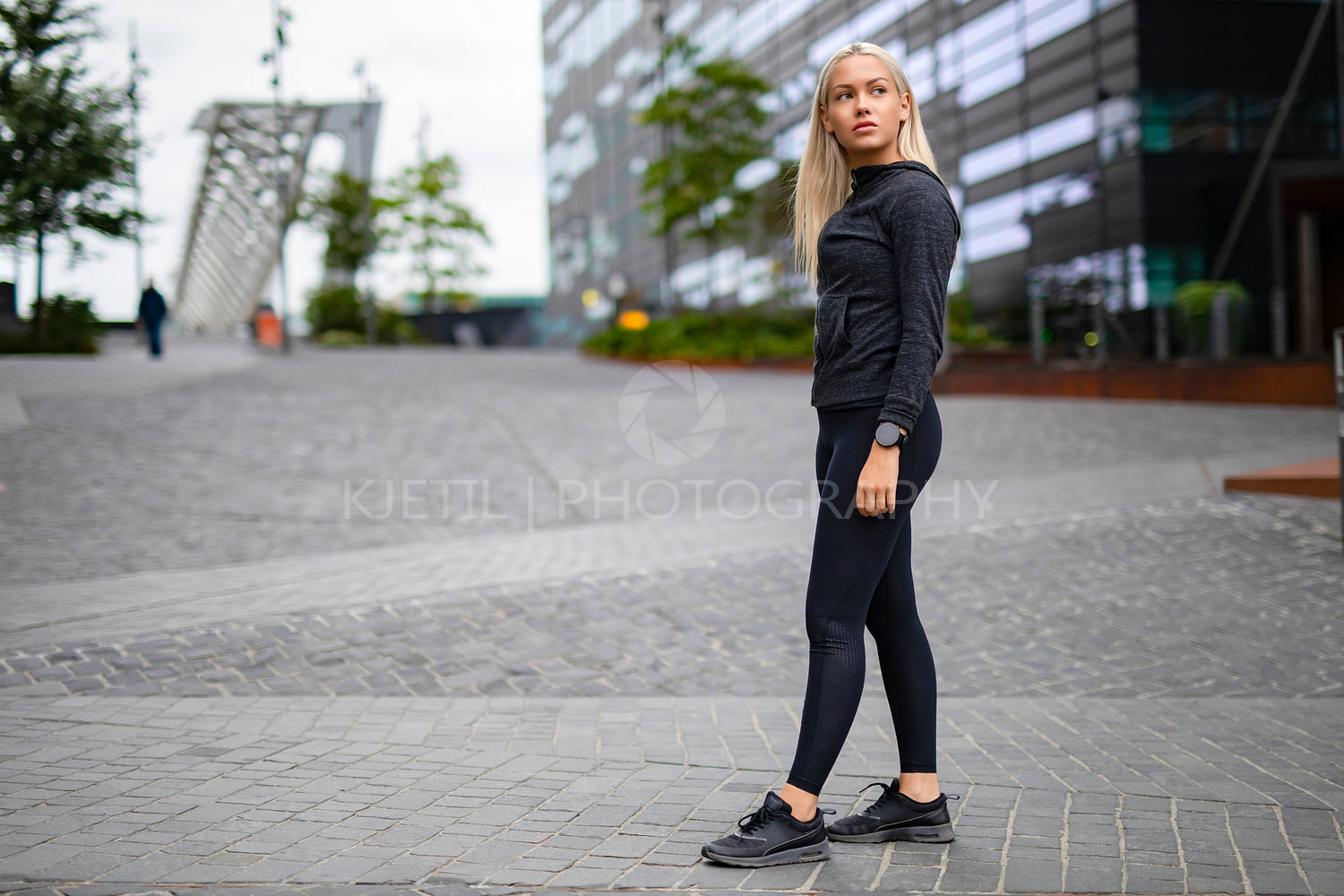 Beautiful urban scandinavian woman in workout outfit standing in city