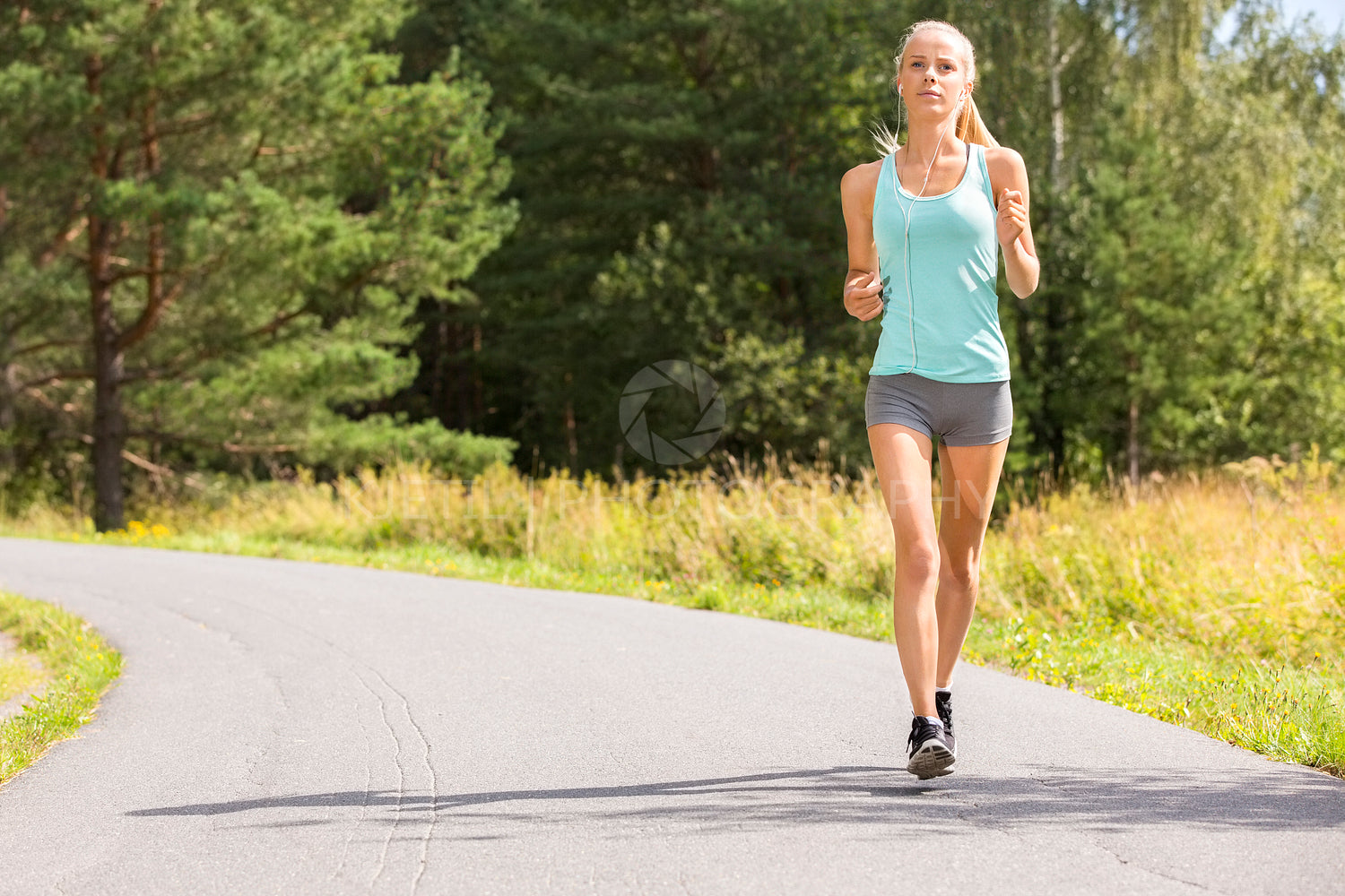 Young woman runs outdoor in the forest