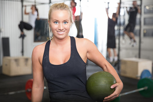 Smiling blonde woman with slam ball