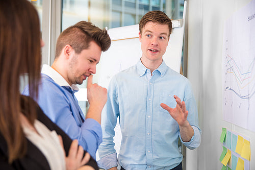 Businessman Gesturing While Communicating With Colleagues