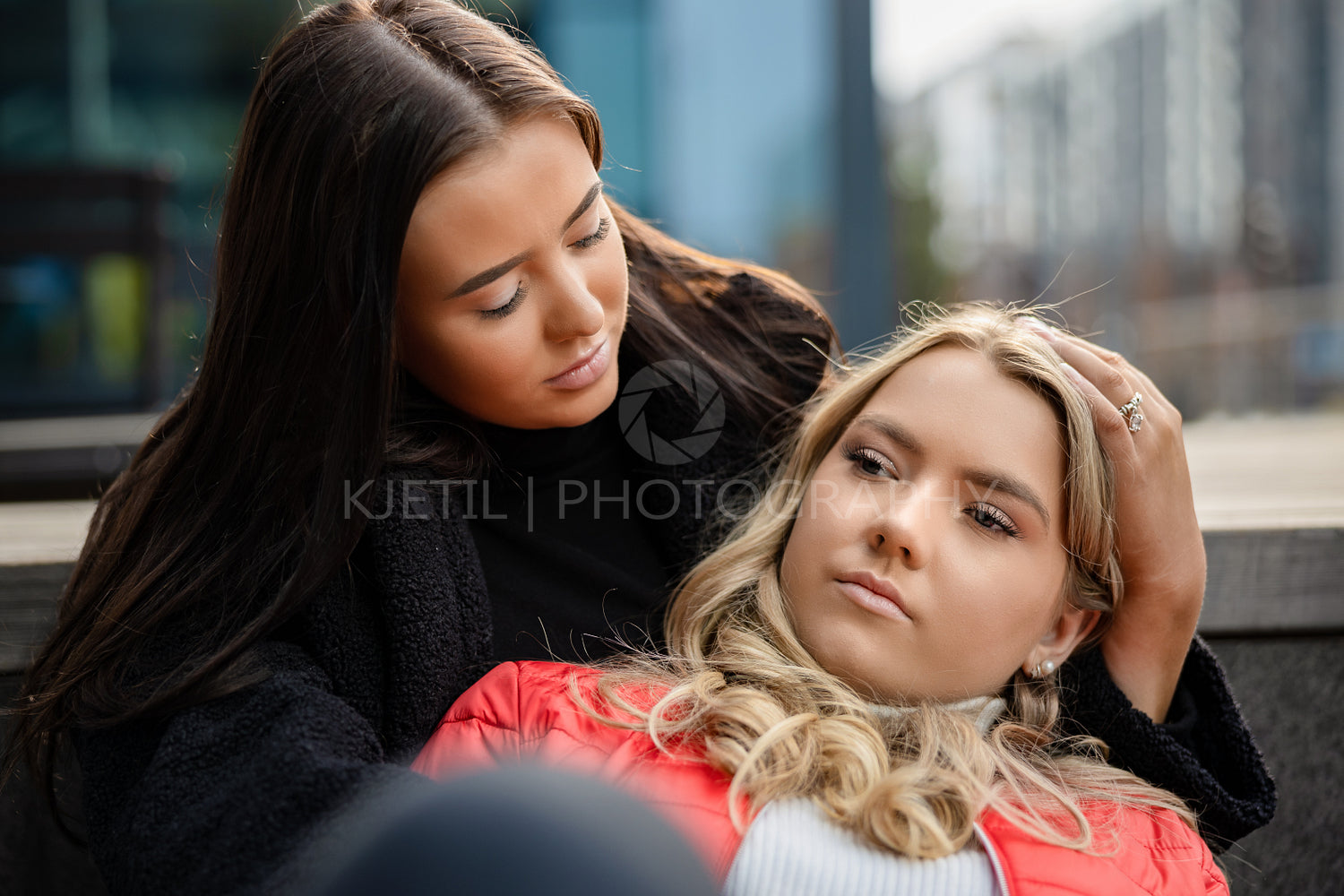 Young Woman Consoling Sad Friend In City