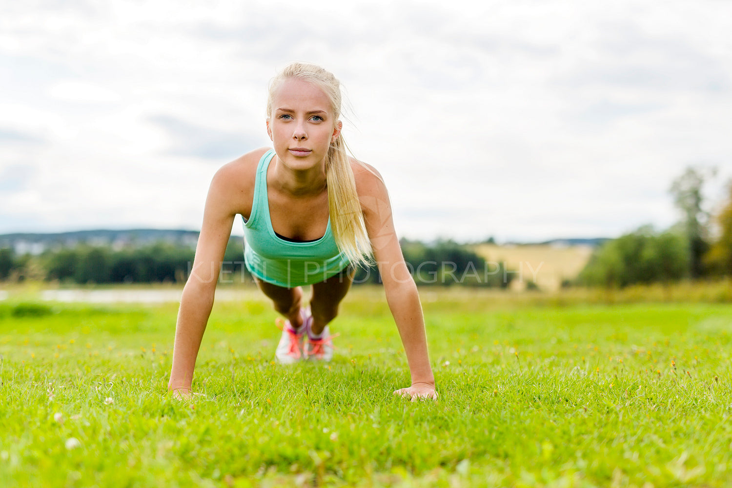 Young woman doing push-ups in the park
