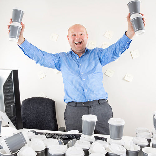 Happy and coffee addicted businessman at office