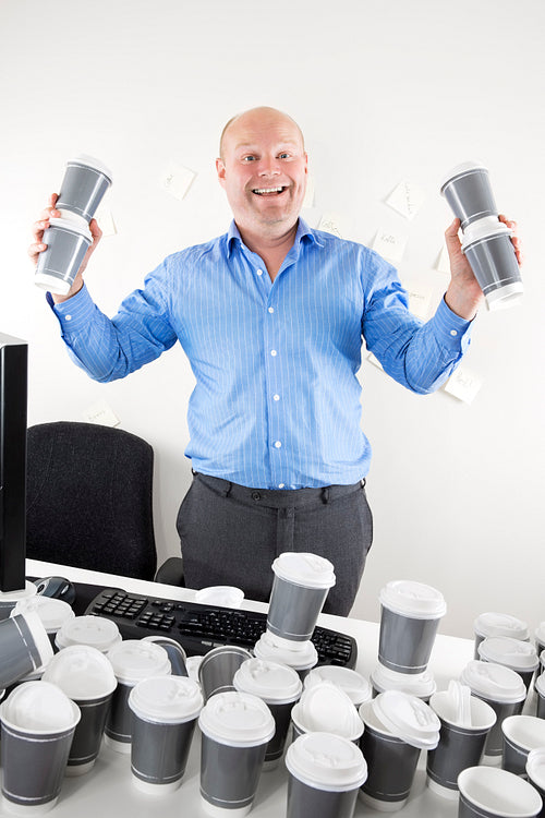 Happy businessman addicted to coffee