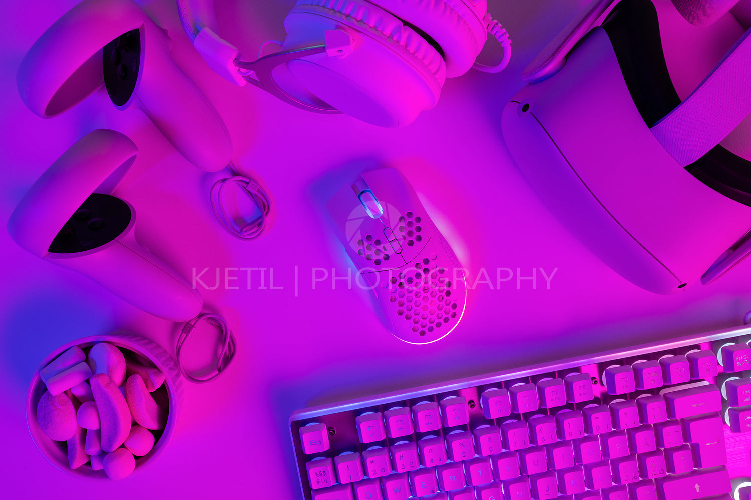 Various modern gaming gadgets on purple desk