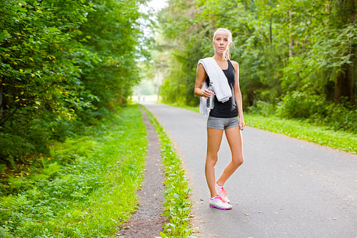 Woman runner rests after workout outdoor