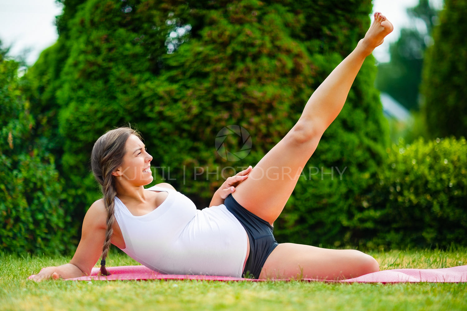 Expectant Woman Doing Side Reclining Leg Lift In Park