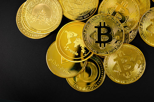 Gold Bitcoin and other Crypto Currency Coins Lying On a Black Background
