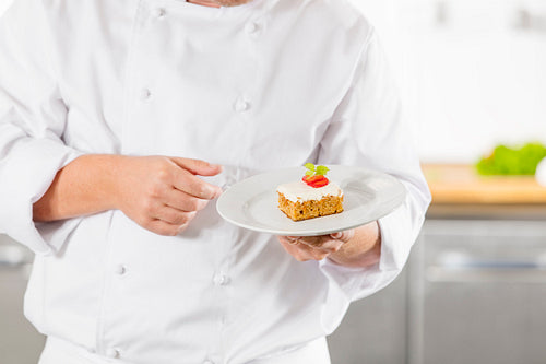 Chef holding dessert cake with strawberry