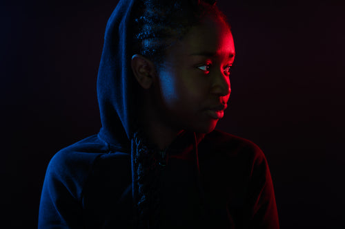 Colorful portrait of cool woman with dark skin wearing hoodie