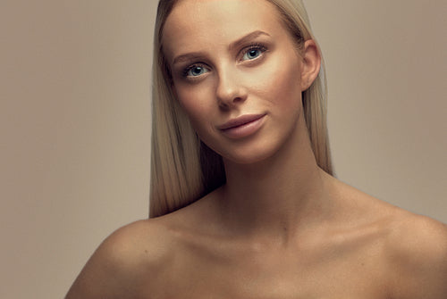 Portrait of a smiling beautiful woman with blonde hair in studio