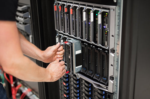 Computer Engineer Installing Blade Server In Data Center