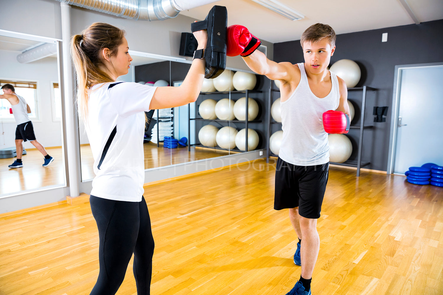 Two dedicated people training boxing at the fitness gym