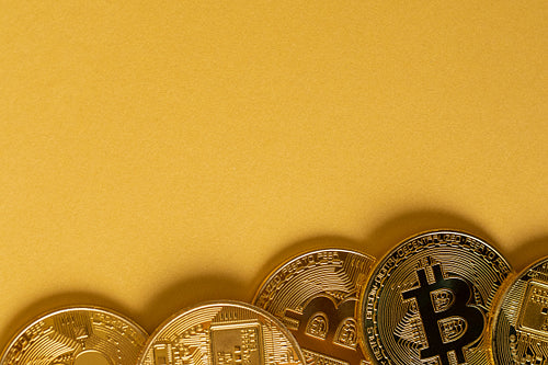Gold Bitcoin Coins Lying On Golden Background