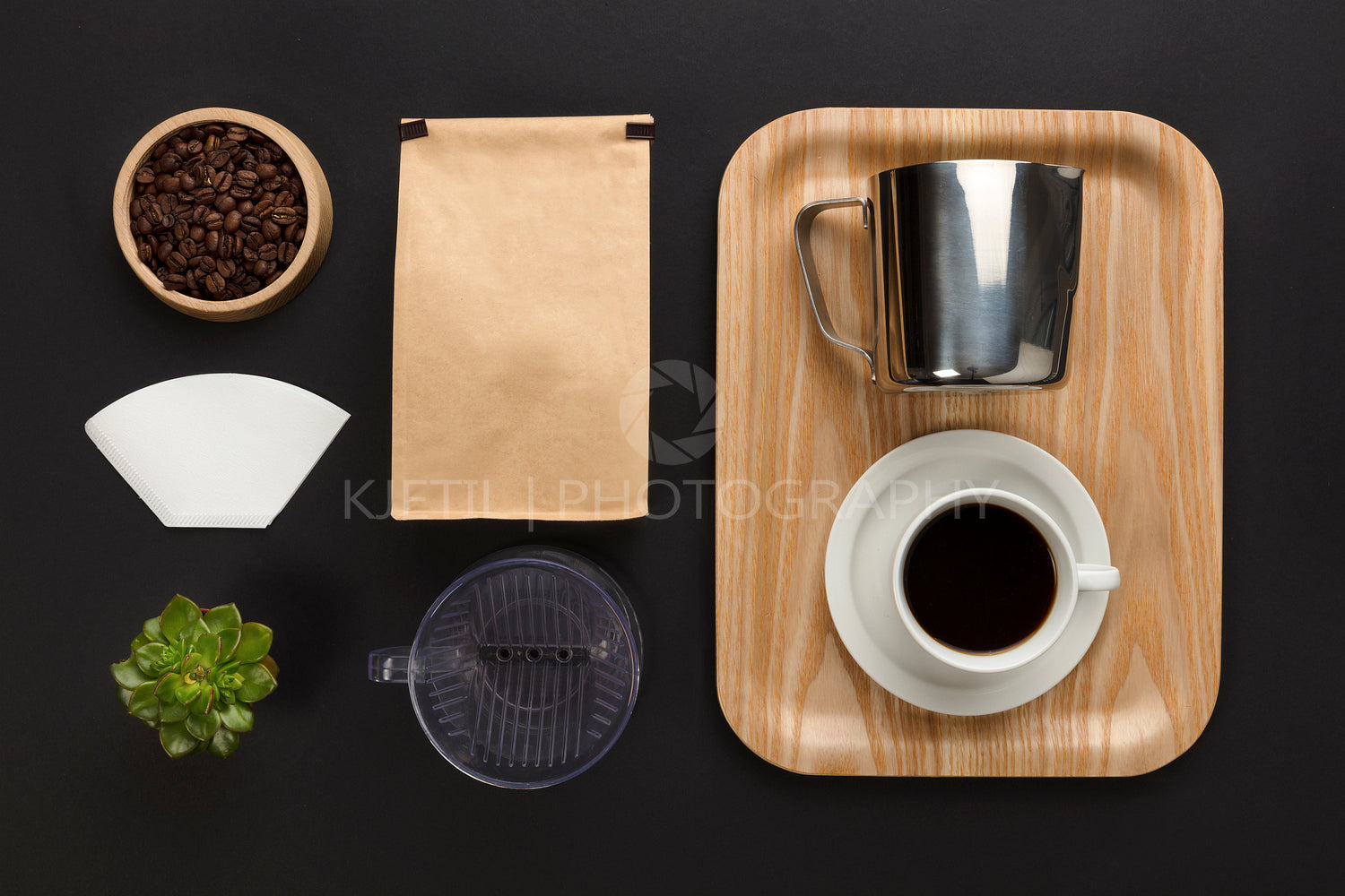 Top view of a black desk with coffee hand brewing supplies
