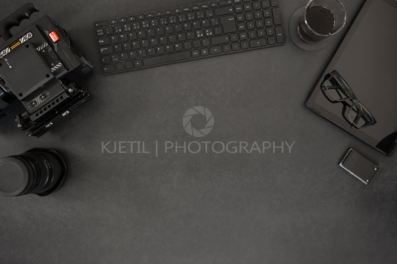 Directly above shot of computer and photographic equipment on table