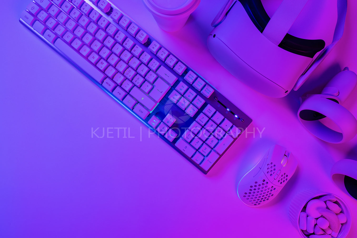 Keyboard with mouse and headphones on blue desk