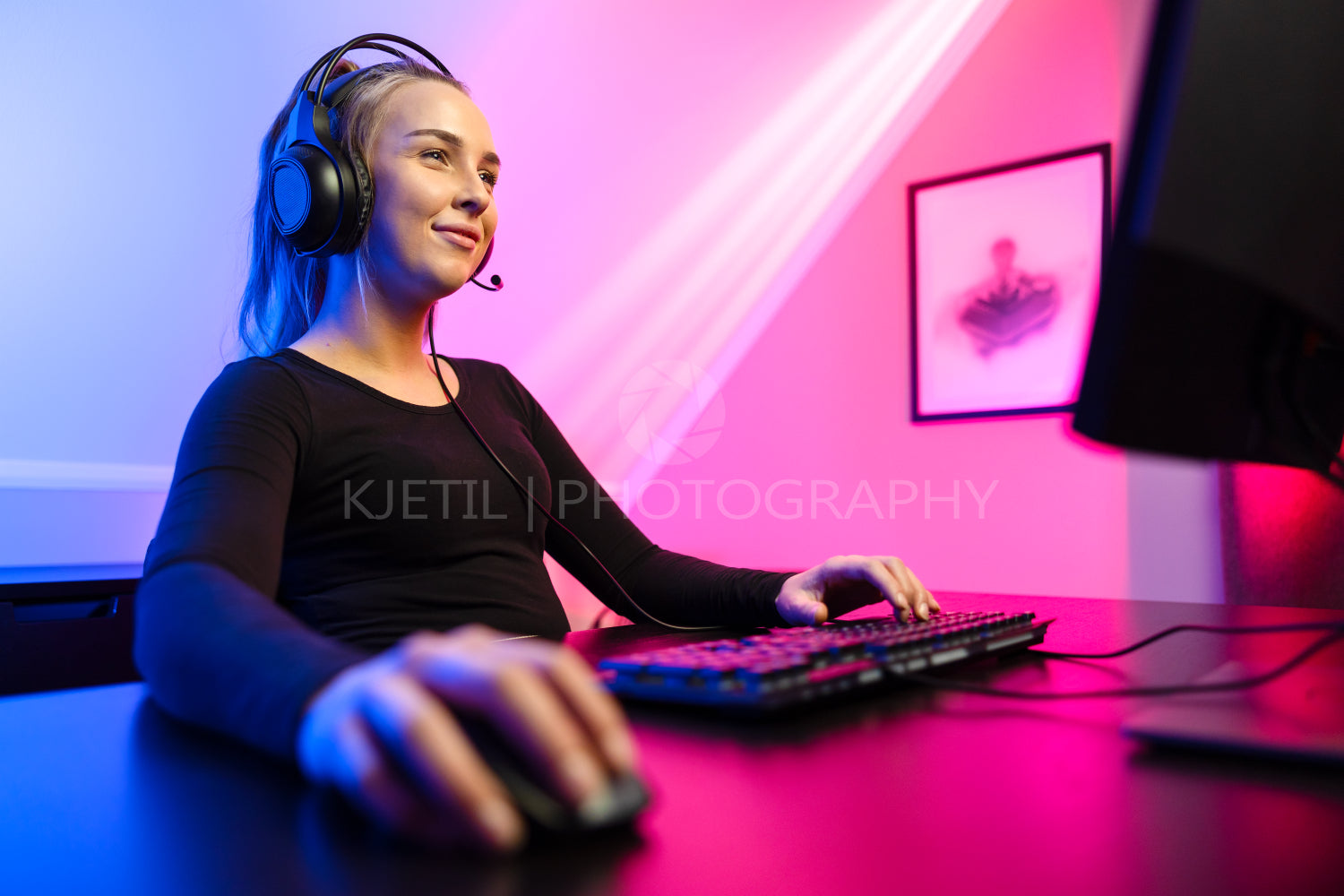 Happy and Beautiful Blonde Gamer Girl Playing Online Video Game on Her Personal Computer.