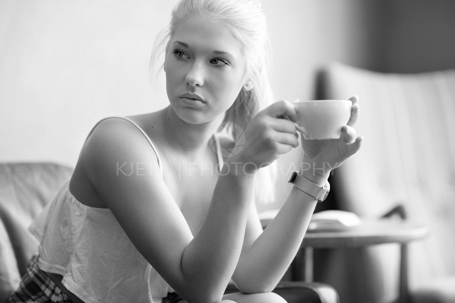 Young and pretty woman drinking coffee at cafe