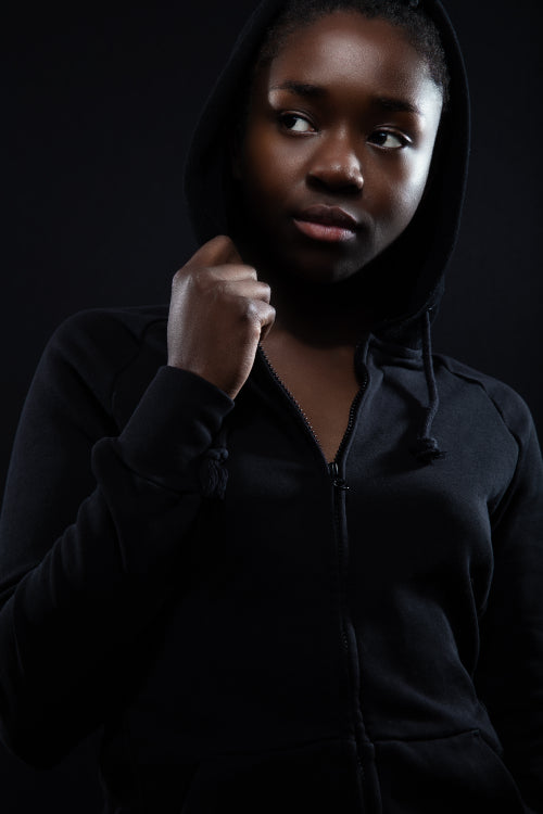 Cool and confident woman with dark skin and attitude wearing hoodie