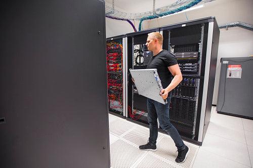 IT Engineer Carrying Blade Server While Walking In Datacenter