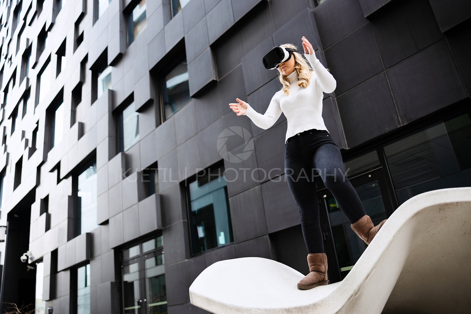 Woman Wearing Virtual Reality Glasses Against Building