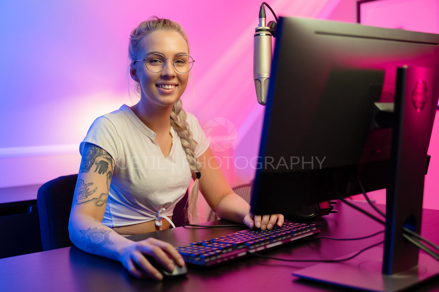 Smiling e-sport gamer girl vlogging and plays online video game on PC