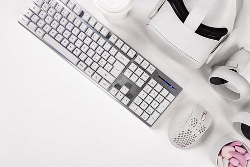 Keyboard with mouse and accessories on white desk