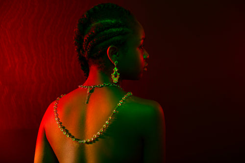 Colorful and creative portrait of pensive african womans back with dark skin