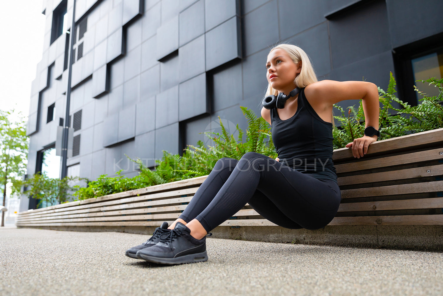 Welltrained Happy Young Woman Doing Triceps Dips in the City